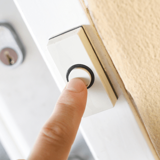 Photo of finger ringing doorbell